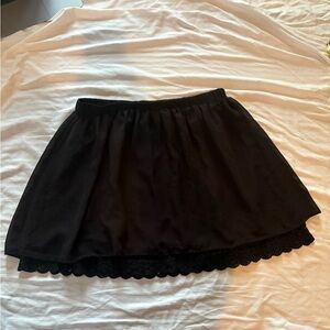 Black mini skirt with lace trim and elastic waistband